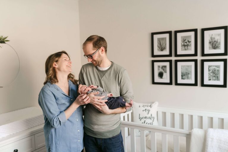 couple holding baby girl in nursery in twin cities mn