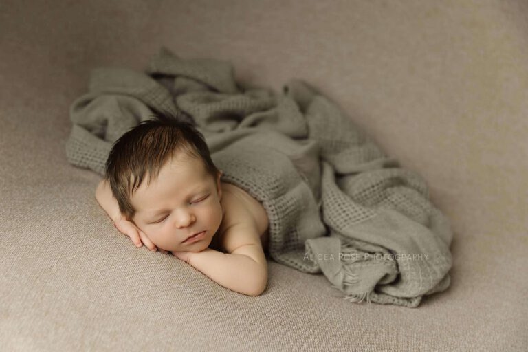 newborn boy posed on stomach