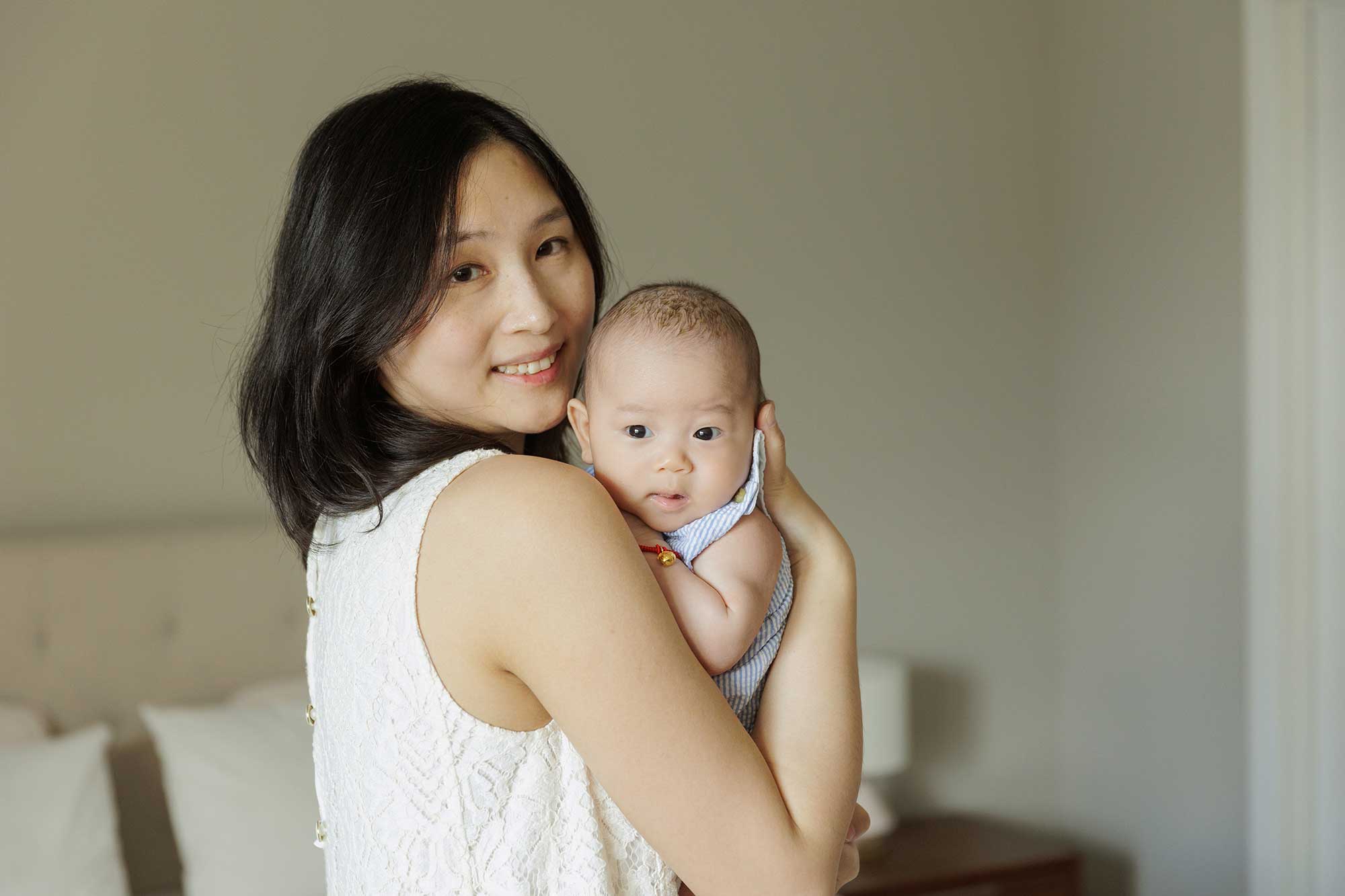 mom holding baby boy celebrating 100 days