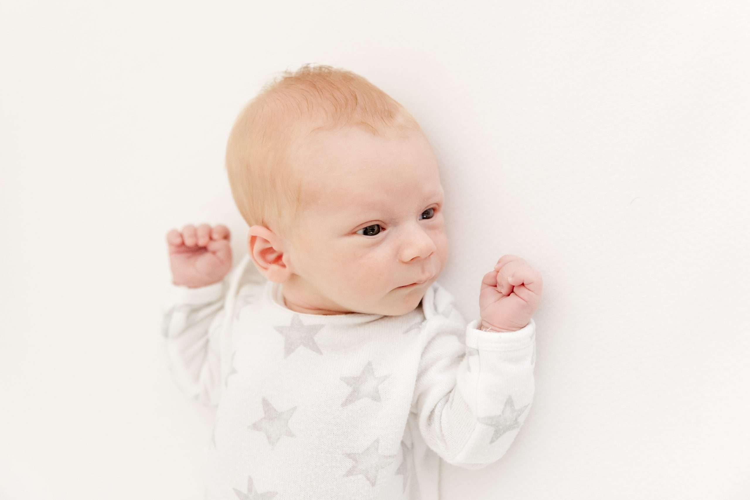 newborn boy lying in crib in nursery in edina mn