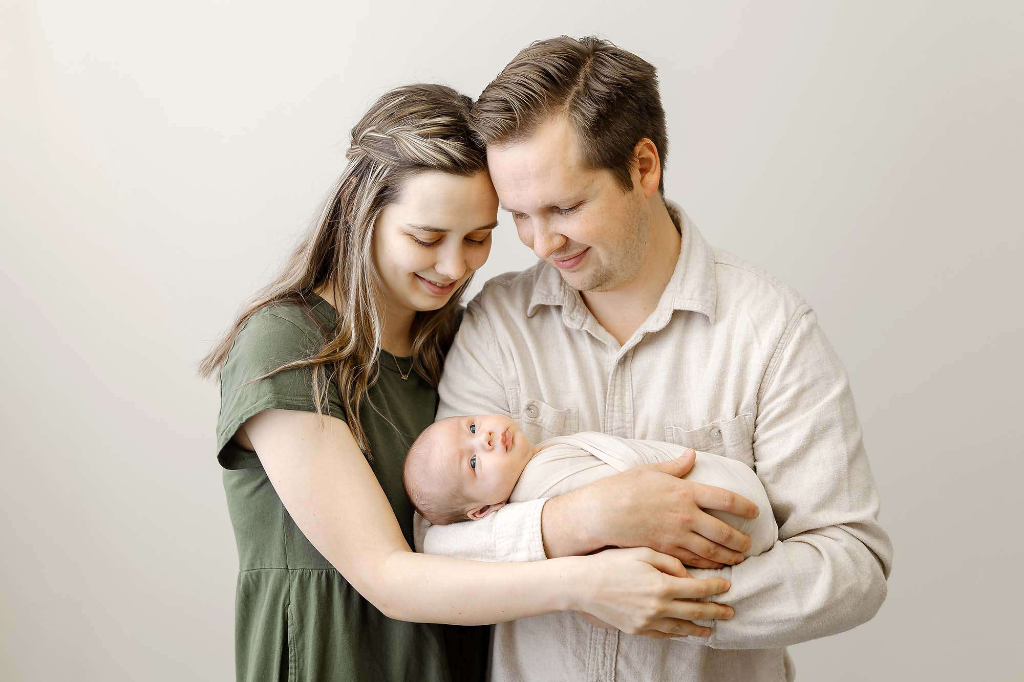 couple holding their newborn baby