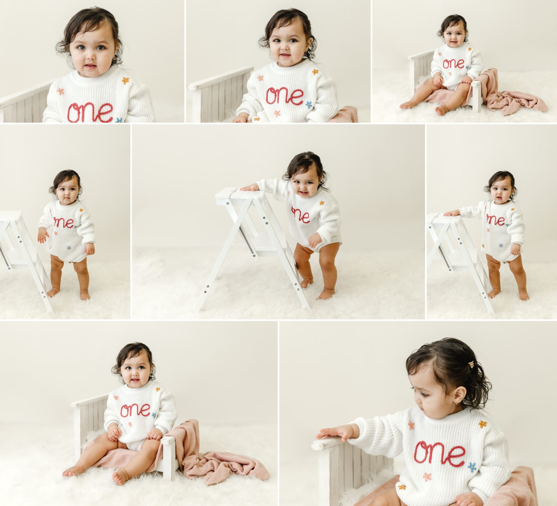 one year baby girl in sweater with one written on it