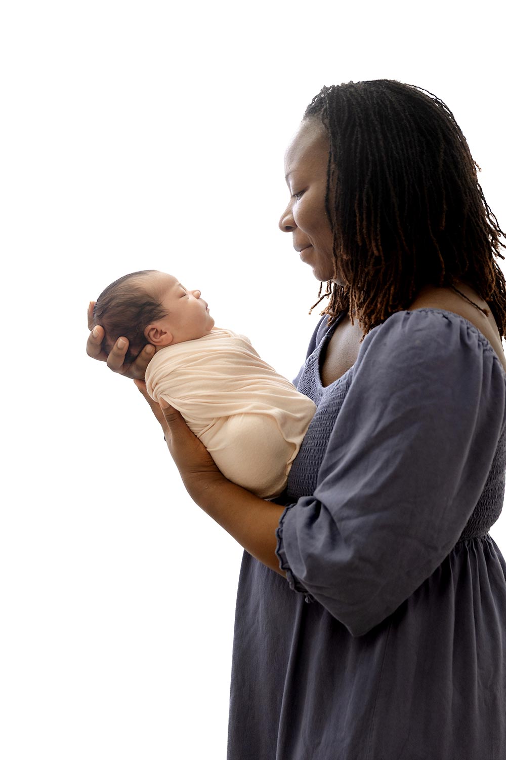 backlit image of mom holding newborn in newborn and family photography studio minneapolis mn