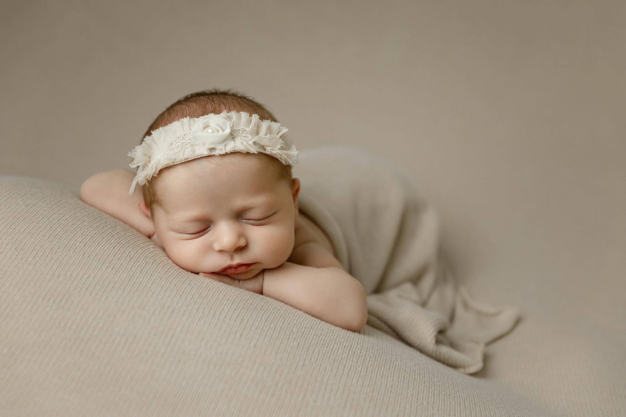newborn baby girl sleeping on her stomach in the studio near champlin mn