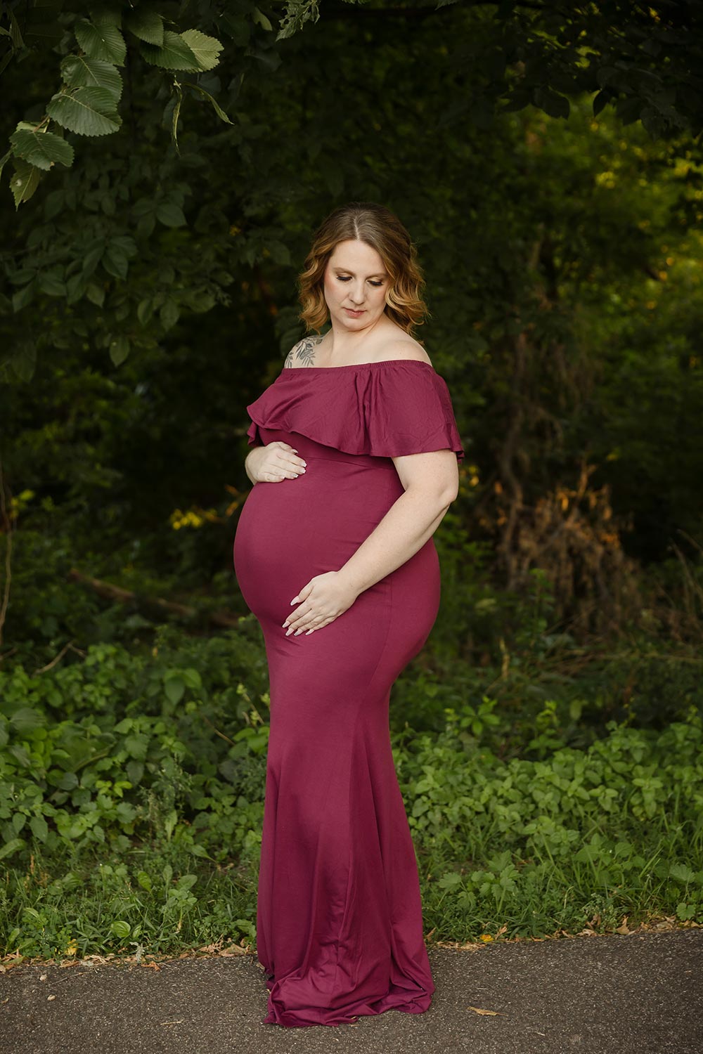 elegant expecting mom posing outdoors at a park in minneapolis mn