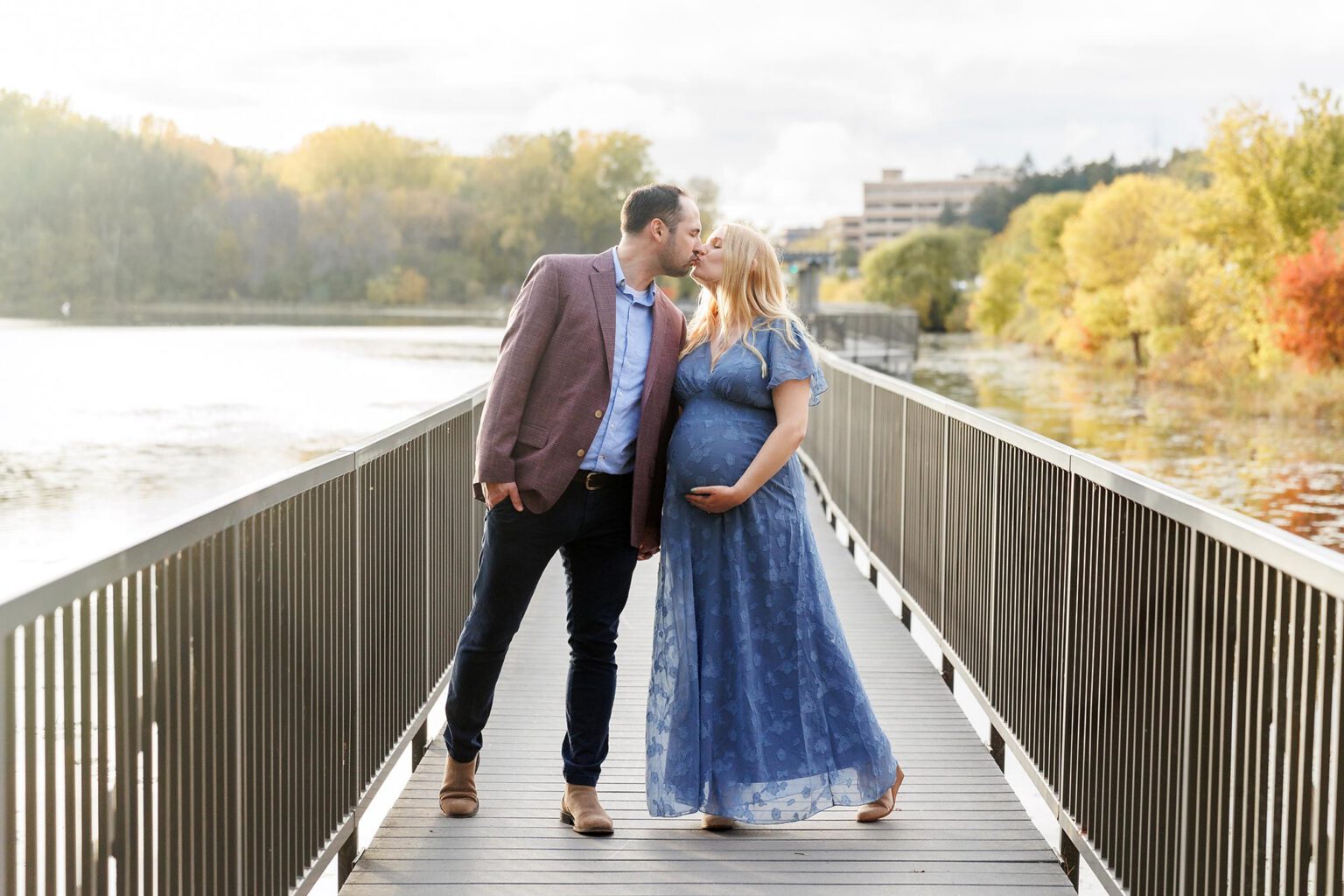 couple posing for maternity photos at Theodore wirth park in minneapolis mn