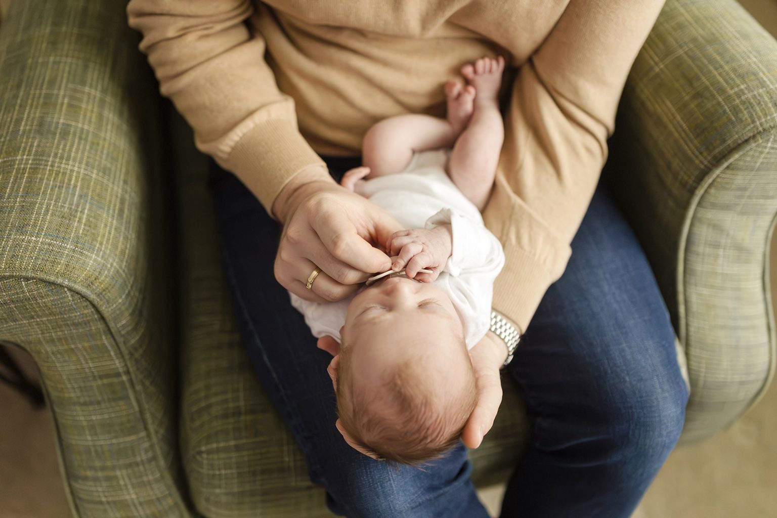 dad holding his newborn baby girl at home in minneapOLIs mn