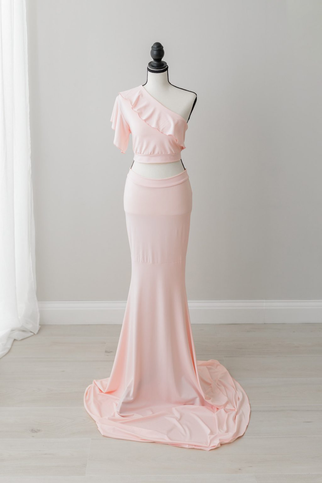 two piece light pink maternity gown showing belly