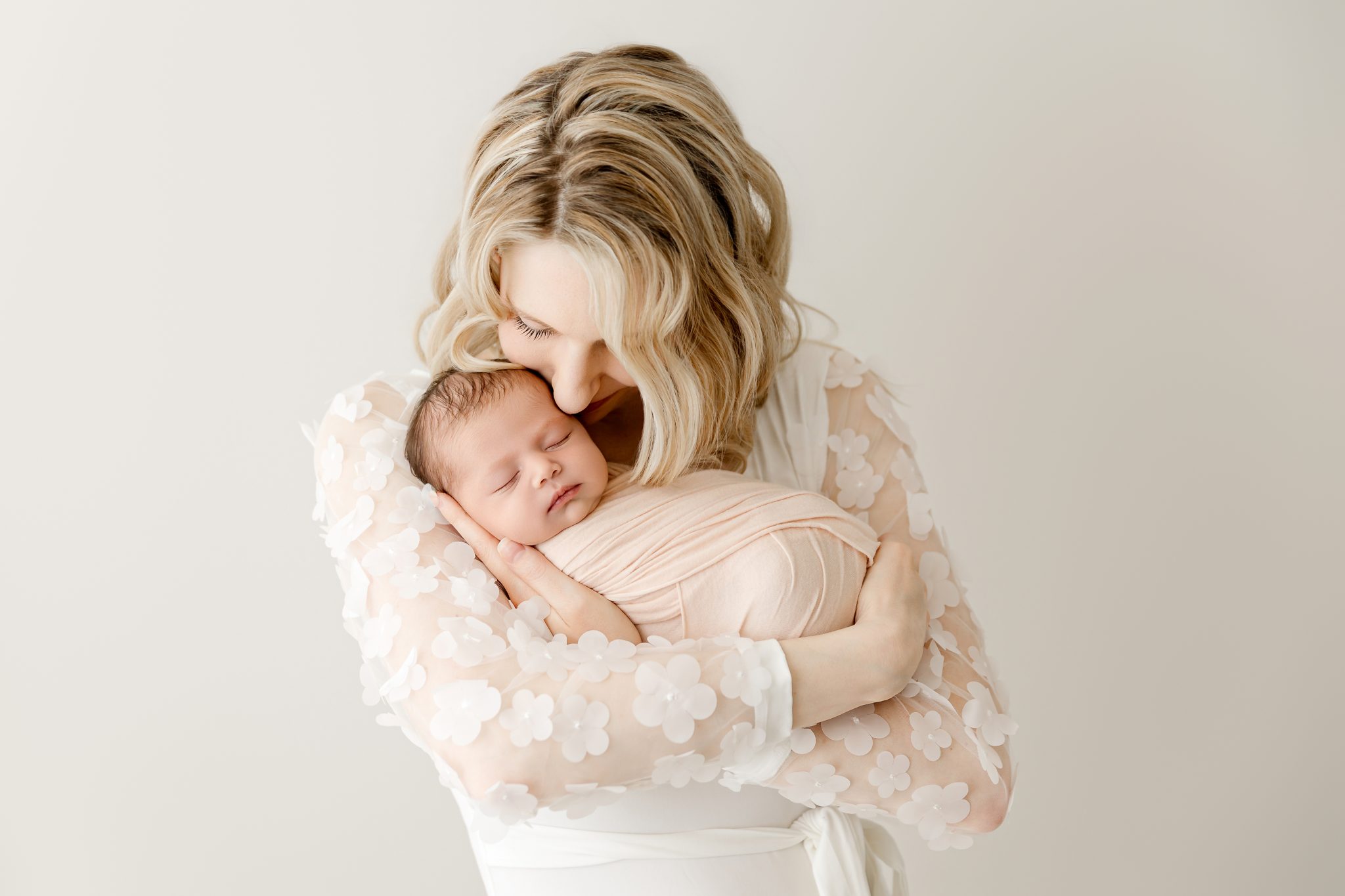 mom holding newborn baby in the twin cities studio
