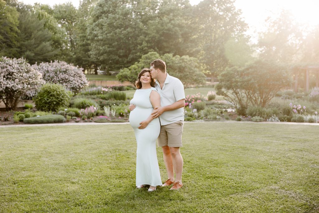 couple standing in noerenberg gardens for pregnancy photos
